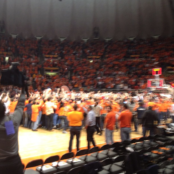 Students and fans celebrate after storming the court as Illinois beats top ranked Indiana at the buzzer