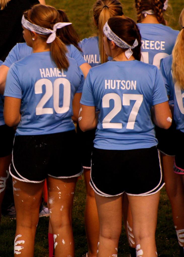 Brianna Hamel and Maddie Hutson standing on the sidelines at the powderpuff game.