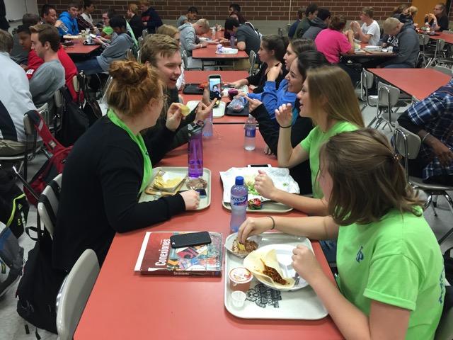 Students in the senior cafeteria discuss the prompt. 