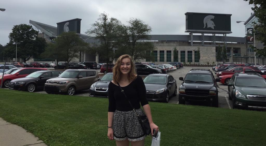 Normal West senior Haylee Sieg poses in front of Spartan Stadium in East Lansing, MI during her first college visit at Michigan State University. Photo courtesy of Kathy Sieg. 

