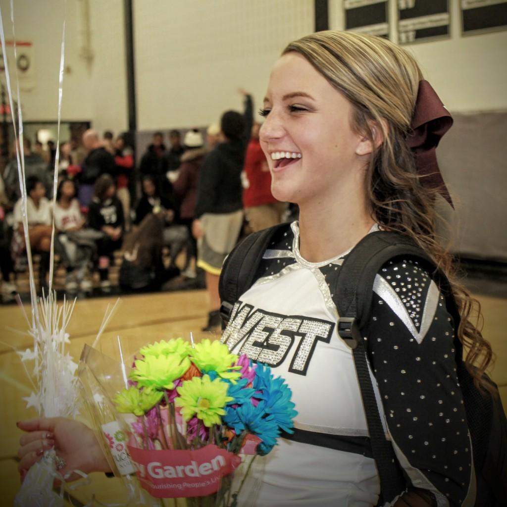 West senior Coed Cheerleading Captain, Hailey Wickenhauser is all smiles after being honored at Fridays game against Champaign Centennial. 