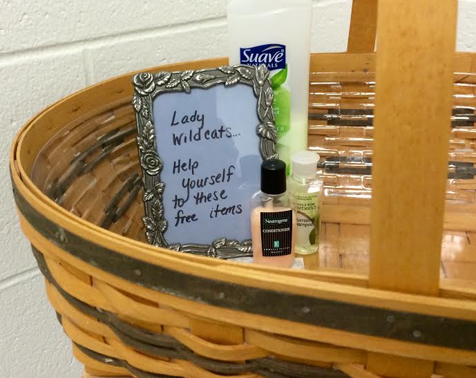 Basket in the girls bathroom with donations of small household items such as lotions, soaps, and shampoos.