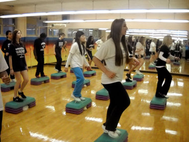 Students keeping active dancing in gym class