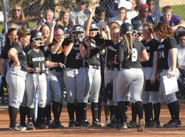 The Normal West softball team congratulates senior Sydney Hollings after hitting a home run against Bloomington