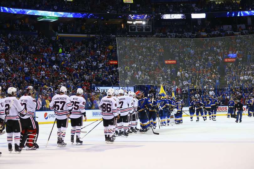Members of the Blackhawks and Blues form a line to shake hands after game seven.
