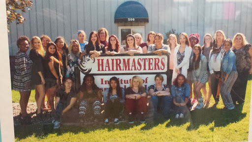 The BACC students in cosmetology pose in front of the Hairmaster’s School.