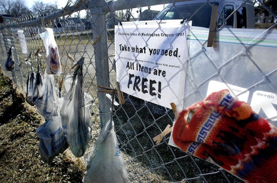 The giving fence reminds everyone to take what they need for free in hopes of helping the community. 
