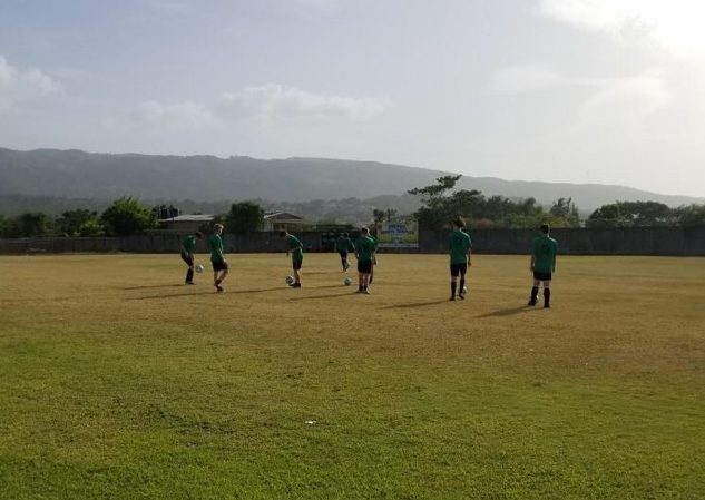 West Soccer players prepare for  a match in front of the scenery that only Jamaica has to offer. 