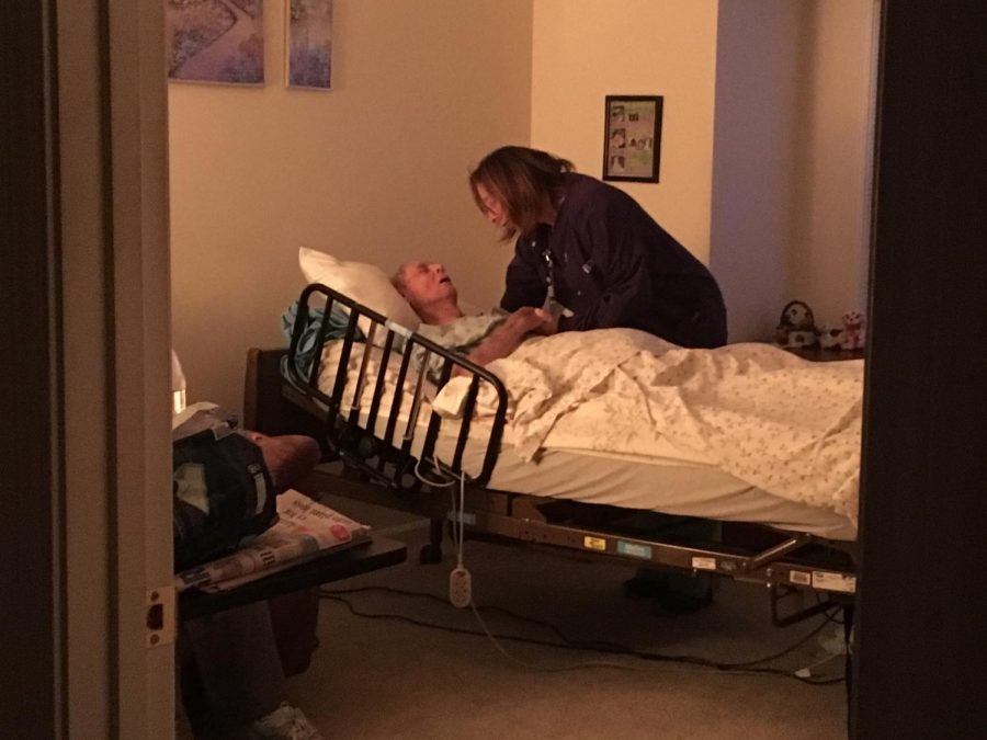Vitas worker Sarah Freestone says goodnight to her patient Raymond at the end of her shift.