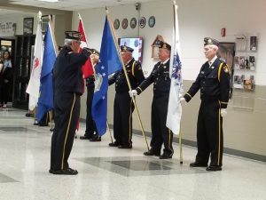 Veterans preform a traditional flag ceremony to honor the five branches of the military, while the Jazz Voices sing the national anthem at the NCWHS veterans dinner on 11/13/2018 