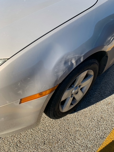 Normal West senior Camden Minister's car after being stuck by a driver entering the parking lot. Photo by Brian Fuss.