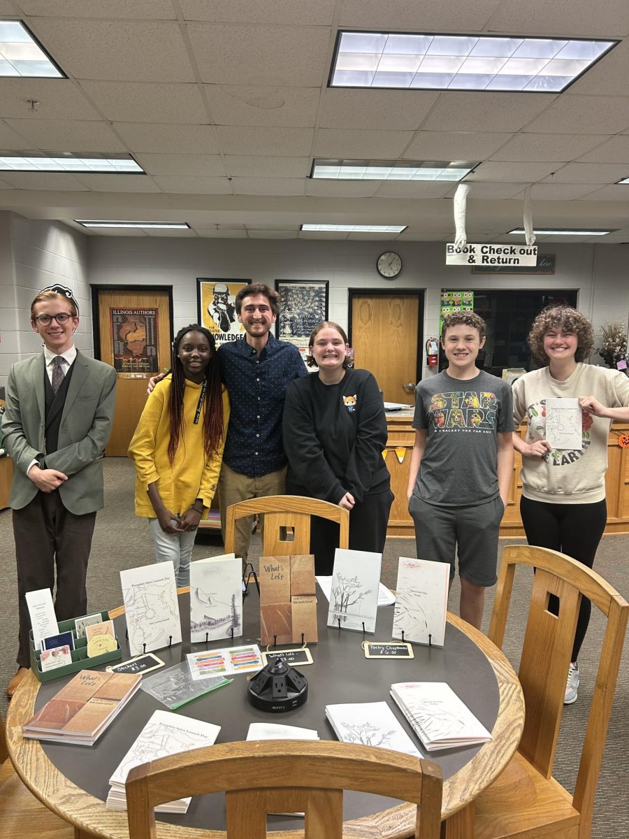 The newly formed NCWHS Writing Club recently had a published author, Tate Lewis-Carroll visit to discuss his writing endeavors. Above, members of the Club pose with Lewis-Carroll.