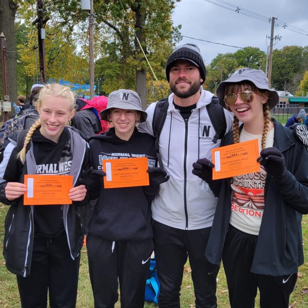 Three Wildcat runners will head to Detweiler Park in Peoria, IL for the 2023 IHSA Cross Country State Championship Meet on Saturday, November 4. The three runners are sophomores Hannah Warren, Renee Warren, and Julie Bach. Above, the girls pose with their head coach, Mr. Chad Aubin after qualifying last Saturday at the Sectional meet.