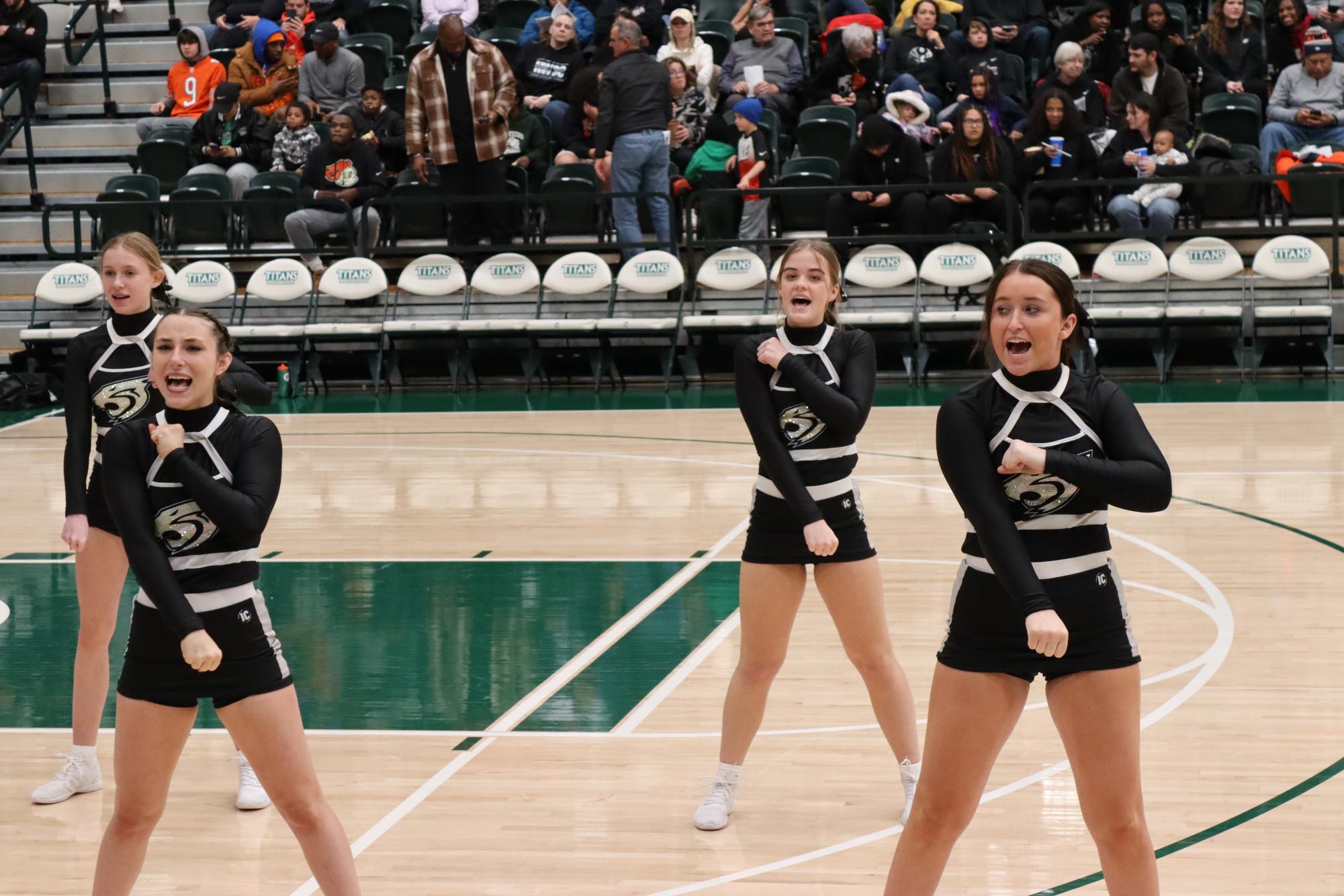 Seniors Makayla Campbell and Maddie Banks lead a cheer during the Boys Intercity Tournament this past week. 