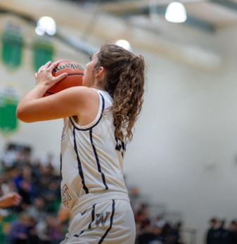 Junior Olivia Kobel eyes the basket in the above photo. Kobel and teammates took a tough loss during last nights game but look to get a win on Saturday against Peoria High School. 
