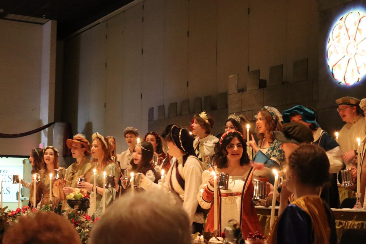 The+Normal+West+Choir+and+Orchestra+performed+their+yearly+Madrigals+show+on+Saturday%2C+Feb+17+and+Sunday%2C+Feb+18+in+the+high+school+auditorium.+Guests+were+entertained+with+various+songs%2C+skits%2C+and+the+infamous+Busy+Corner+pie+as+students+took+them+back+in+time+for+the+performance.