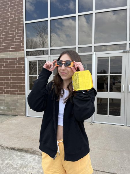 Senior Eden Husarik tests out her eclipse glasses. We have a rare chance to see an eclipse, one of nature’s most intriguing sights. The next one is set for 145 years in the future.
