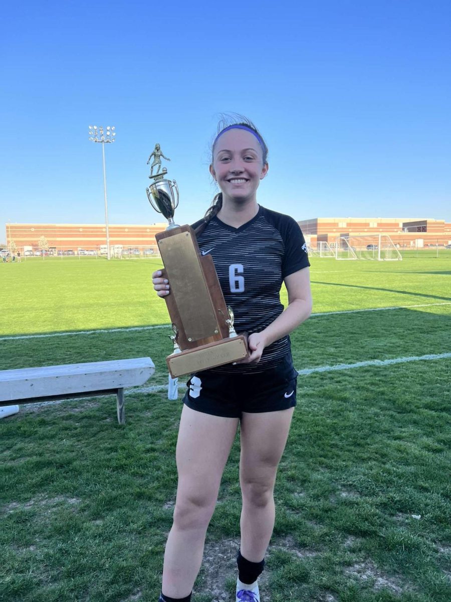 Senior Meredith Bertsche poses with a trophy from last season. Bertsche is a 4-year Varsity letter winner and an athlete that head coach Valentine Walker is looking to for senior leadership.