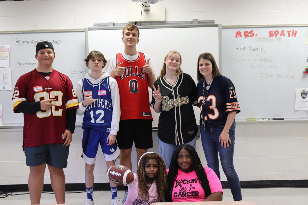 Wednesday's theme was Mathlete vs. Athlete for underclassmen and Jersey Day for seniors. Because the themes were similar, the halls were full of various sports fans! Seniors Ben Stackhouse, Hunter Reid, Owen Voorheis, Katie Munson, Mrs. Natalie Spath (teacher), Jenna Washington and Karma Powell all took a moment to celebrate the day.