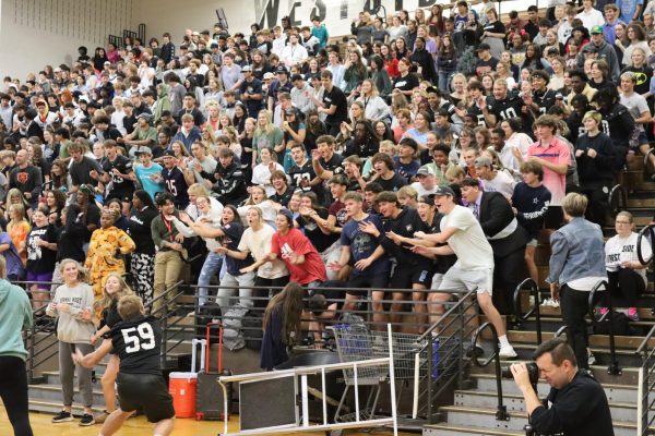 Senior Charlie Moore leads the senior class in a spirited cheer during Thursday, Sept 26's homecoming assembly. The seniors took the spirit stick this year after dominating multiple games.