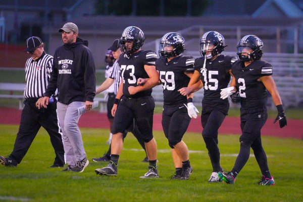 Coach Nate Fincham, along with senior captains, Kyle Thoennes, Charlie Moore, Abram Rader, and Cooper Temples head into the captain's meeting prior to the game against Peoria High School last Friday. The Wildcats went on to pull of a huge upset, beating Peoria, who was ranked 6th in class 5A at the time of their meeting, with a score of 20-18