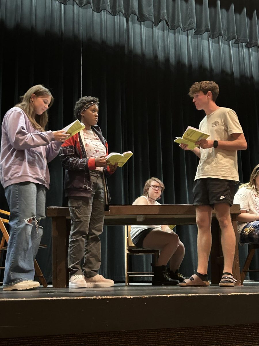 Normal West Theatre is getting set to present their latest production, Arthur Miller's 'The Crucible,' this weekend. Seniors Gabby Namoff, playing Mary Warren, Lyn Southall, playing Elizabeth Proctor, and Junior Dane Schlipmann, playing John Proctor rehearse their lines in preparation for the upcoming show. Showtimes begin at 7 p.m. on Friday, October 11 and Saturday, October 12. Sunday's show begins at 2 p.m.