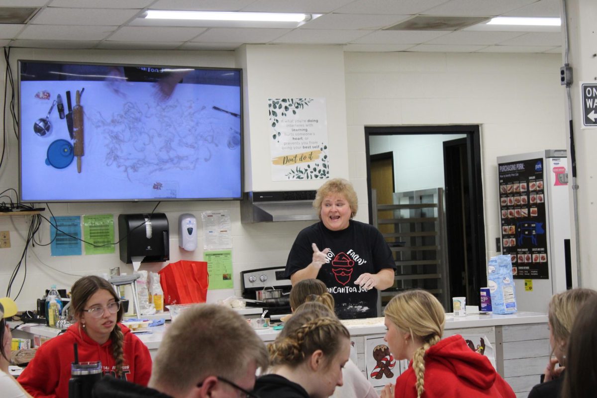 Normal West Math teacher, Mrs. Patty Saal volunteers with culinary arts teachers to show West students how to create her favorite dish: chicken &  noodles. Saal, along with various other staff members and student groups enjoyed their time sharing their favorite gifts. 