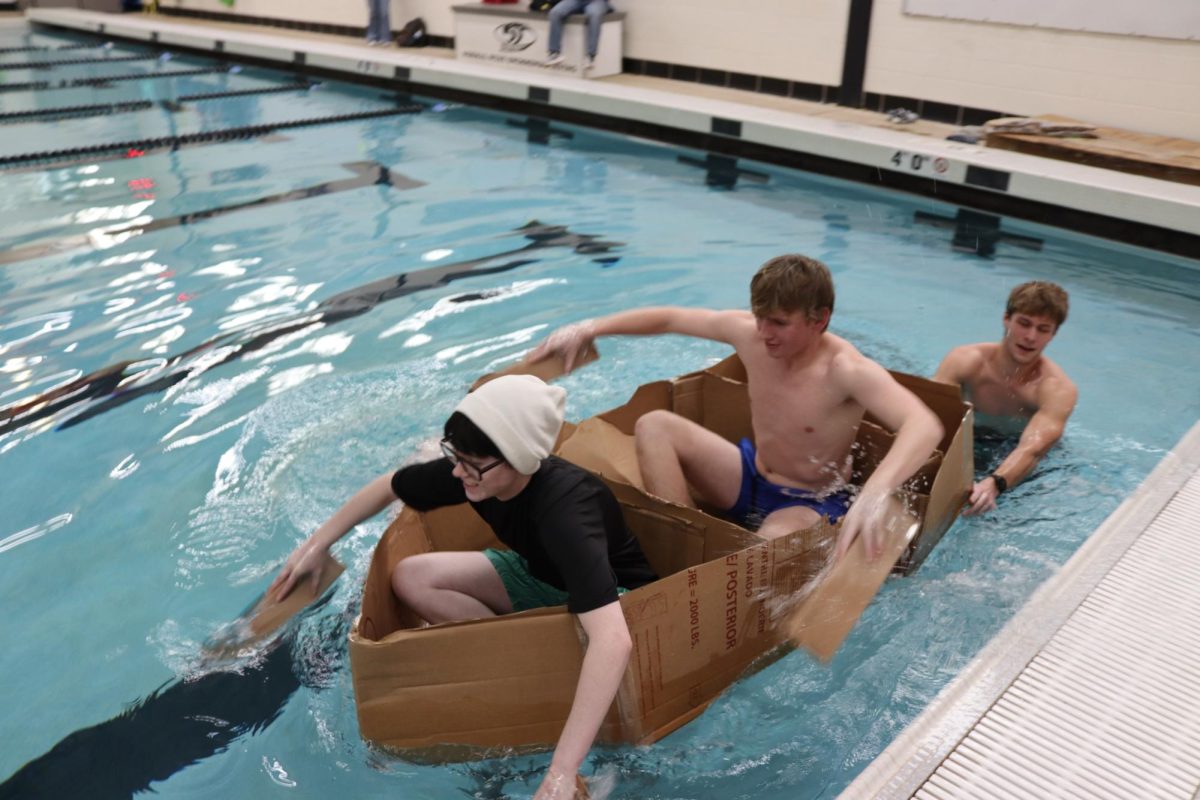 Teammates Junior Calvin Beyers & Senior Jack Hanks took the victory in this year's AP Physics Boat Regatta, alongside teammates Charles Brown II & Sebastian Liles, who helped design and direct the boat. Members of the AP Physics class worked together to create a cardboard boat with tape adhesive to see whose could last the longest in the Normal West pool on Thursday, January 16.