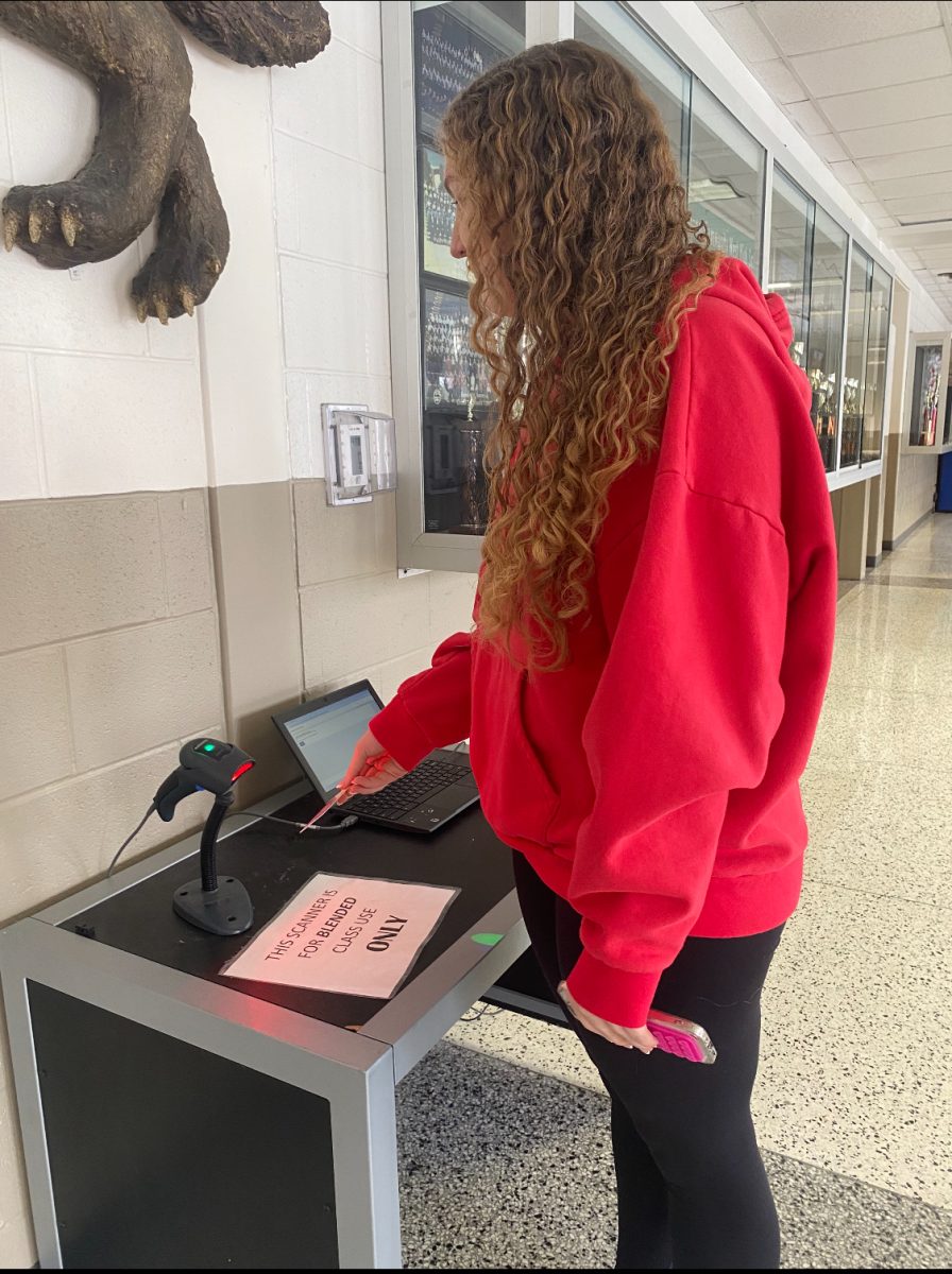 Above, junior Makinzee Boyer scans out for her blended class hour in the band hallway blended lab.
