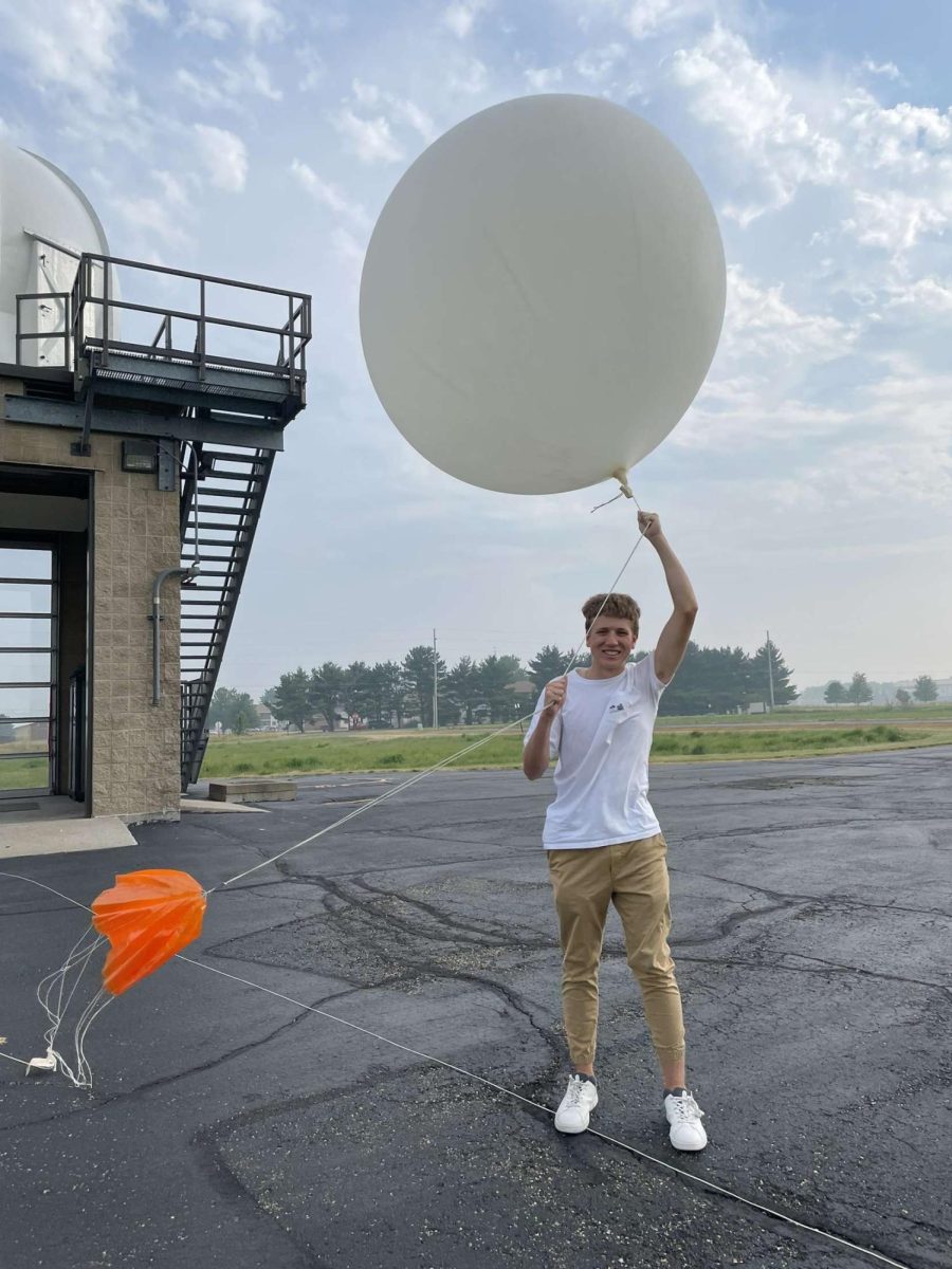 Tyler Hoss has turned an interest in weather into a passion project. Hoss has started his created his own audience through social media. Above, Hoss poses with one of his weather balloons.