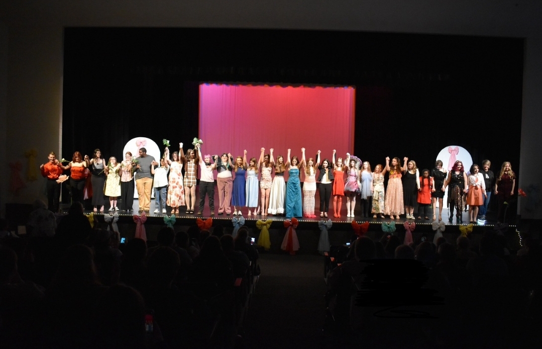 Seniors Mackenzie Miller and Simon Glim-Gessee were tasked with the second annual Normal West Fashion Show after founder, Kyle Tidabeck began the tradition just last year. In the above photo, the participants from the 2025 show, including Dr. Angie Codron, the principal at Normal West, pose at the conclusion of the event. Students, staff, and community members gathered in the auditorium to watch the student-fashion in action.
