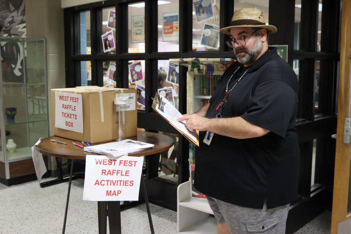 Mr. Anthony Berardi has been at Normal West since the school opened its doors, and one of his major impacts on the school is his organization of a student-favorite: West Fest. West Fest is a student carnival put in place to celebrate another school year. This year, West Fest will take place on Friday, May 2. Above, Mr. Berardi poses with the map and raffle ticket box from last year's celebration.