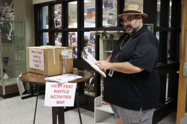 Mr. Anthony Berardi has been at Normal West since the school opened its doors, and one of his major impacts on the school is his organization of a student-favorite: West Fest. West Fest is a student carnival put in place to celebrate another school year. This year, West Fest will take place on Friday, May 2. Above, Mr. Berardi poses with the map and raffle ticket box from last year's celebration.