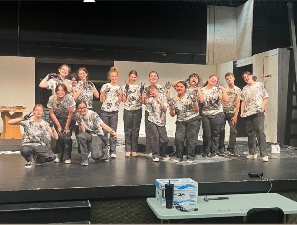 Many of the ensemble crew stopped their set build to smear black paint on their worker costumes to appear like coal workers. Hadestown: Teen Edition will hit the stage this weekend with various shows. 