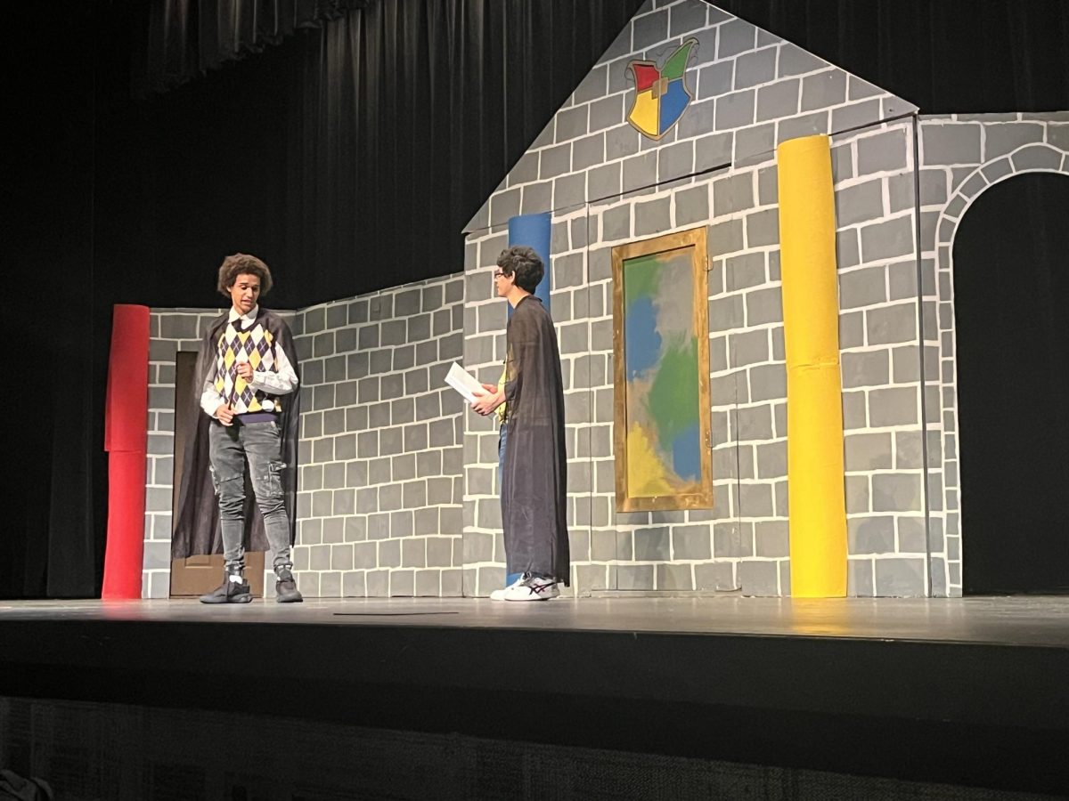 Avove, Junior Jaxson Thibodeaux, who plays Cedric in this year's production of 'Puffs," interacts with Leo Vargas, who plays the main character named Wayne Hopkins. Although Thibodeaux is a returning thespian for Normal West theatre, Vargas is debuting his acting career. Catch 'Puffs' this weekend at Normal West!