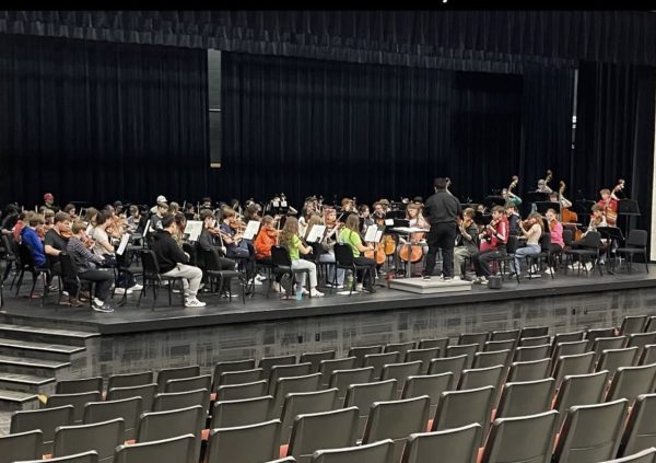 The Normal West High School orchestra prepares in rehearsal for their upcoming performance on Thursday, October 30. This year's Hauntcert will be themed as "Halloween Heist," and orchestra director Kim Boehm is excited to share her students' work with the general public.