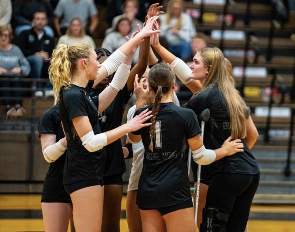 The Normal West Wildcat 2025 volleyball team has certainly faced their share of adversity this season, but Head Coach Kelsey Mueller is proud of the positive attitude that each member of the team has provided. Above, seniors Olivia Ziemer (left), Jaiden Temples (center), and Avery Feltes (right) lead the huddle before a matchup. Ziemer and Feltes are two of the Wildcats who have fought injuries this season, and Feltes remains out.