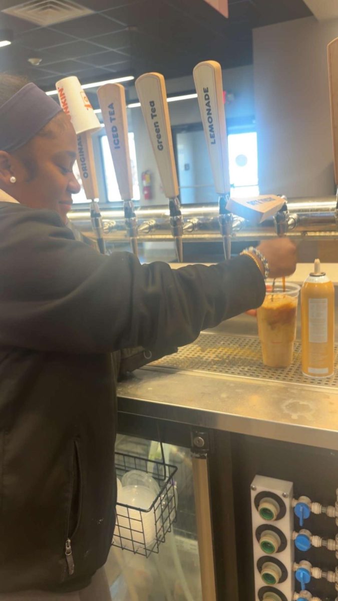 Senior Jayden Jones was desparate for a job and applied to almost 20 separate places.  When she was hired at Dunkin' Donuts, she had no idea she'd find so much success! Above, she serves up a delicious ice coffee for a customer.