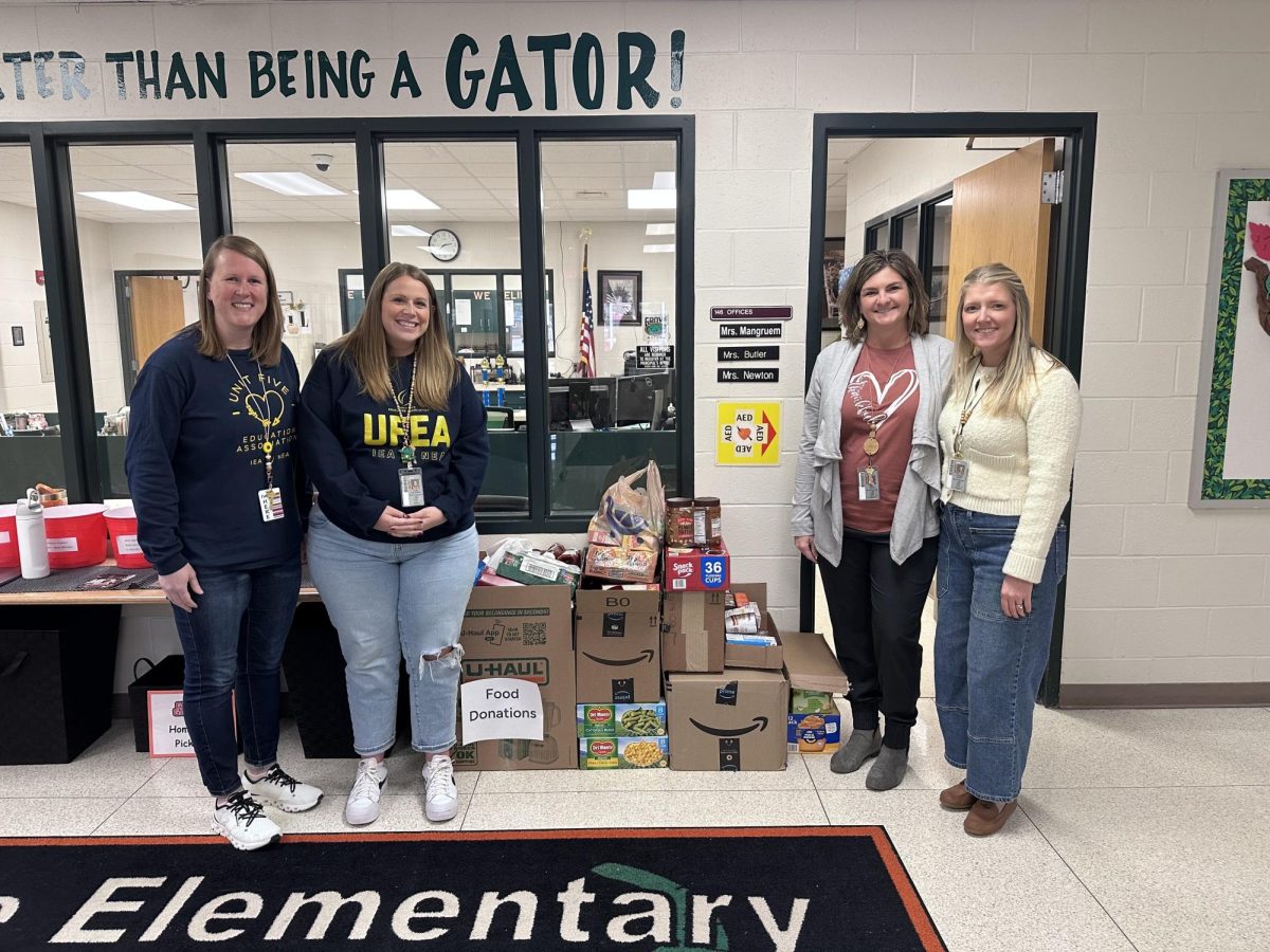 Unit 5 schools recently held a Food Drive for families across the district. Above, members of Grove Elementary School pose with their collection.