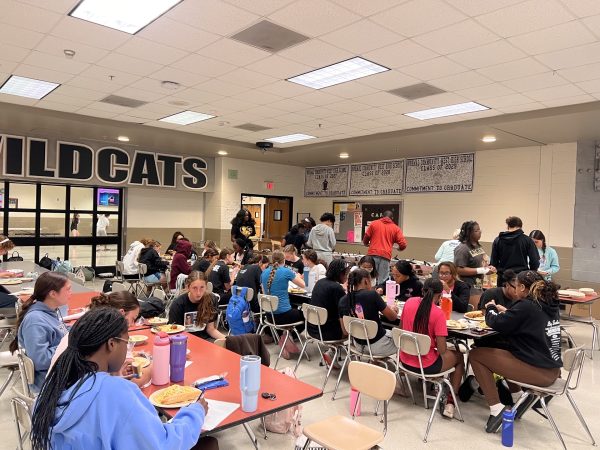 The Normal West track team is known for their speed and strength at the track, and as important as the drills and practice they put in is, the Wildcats also recognize that team bonding is important, too. Above, the team shares a team meal, a coveted part of being on their team.